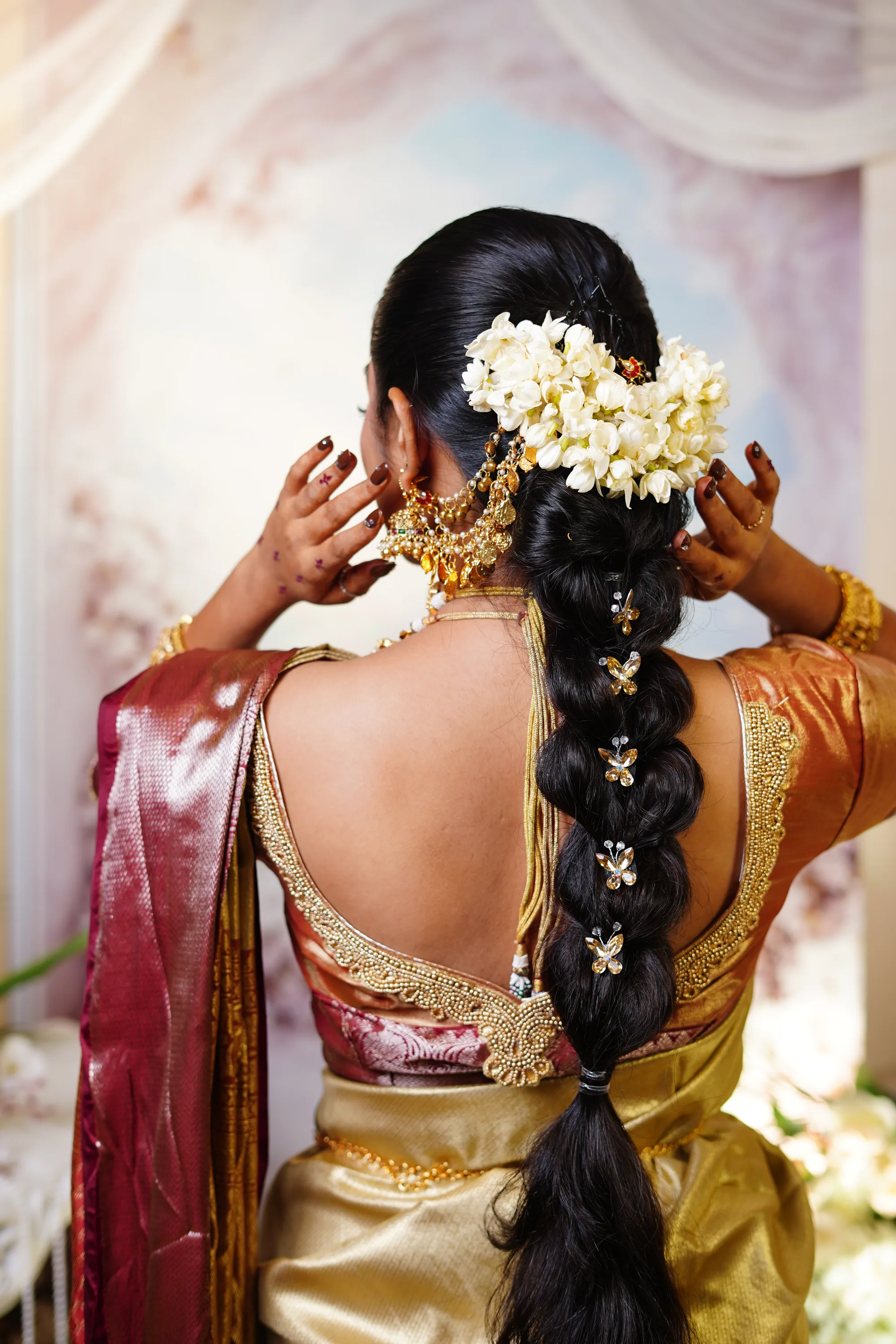 Bride fastening jasmine into her braid