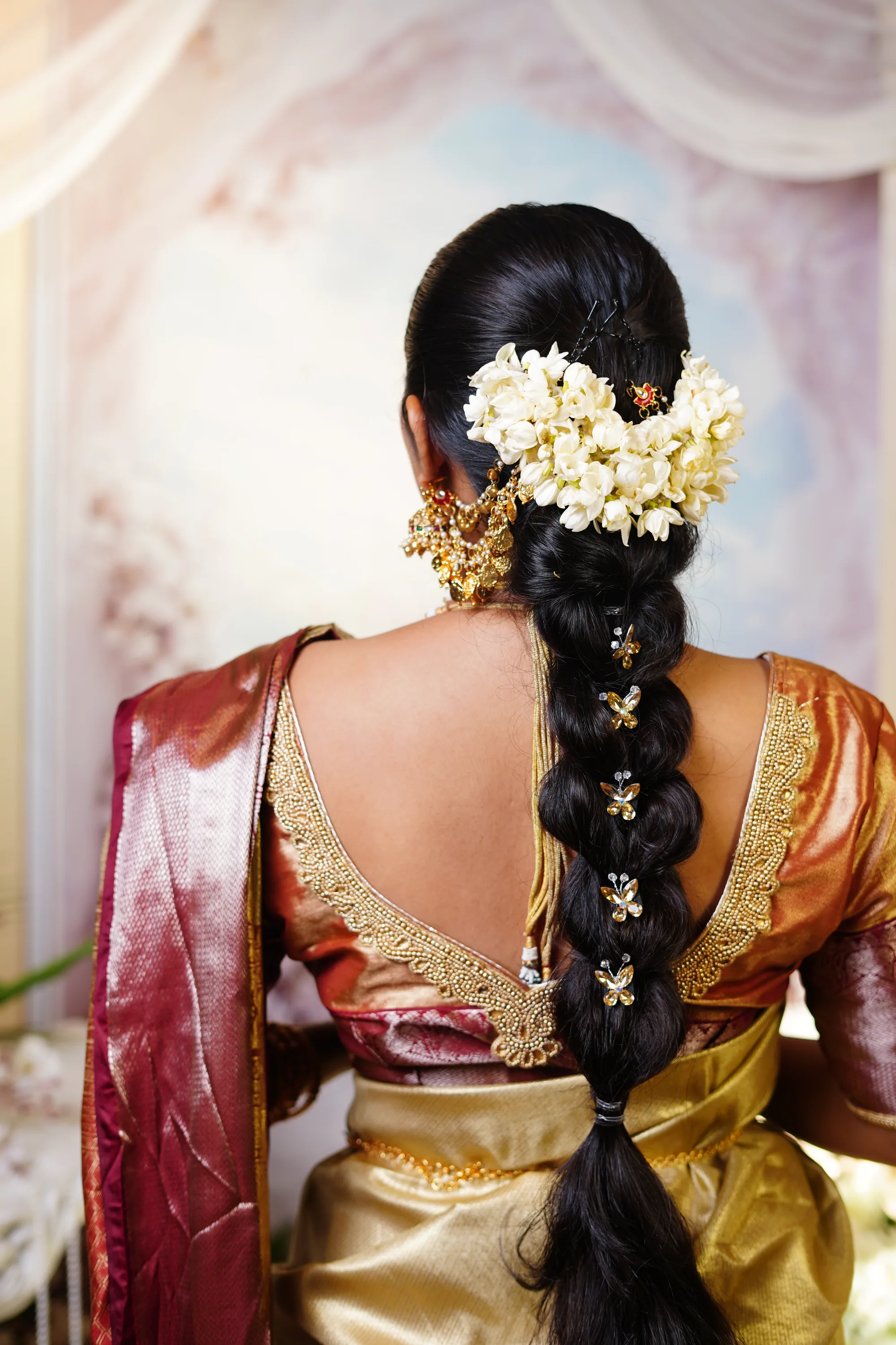Jasmine and butterfly pins set into a bridal braid