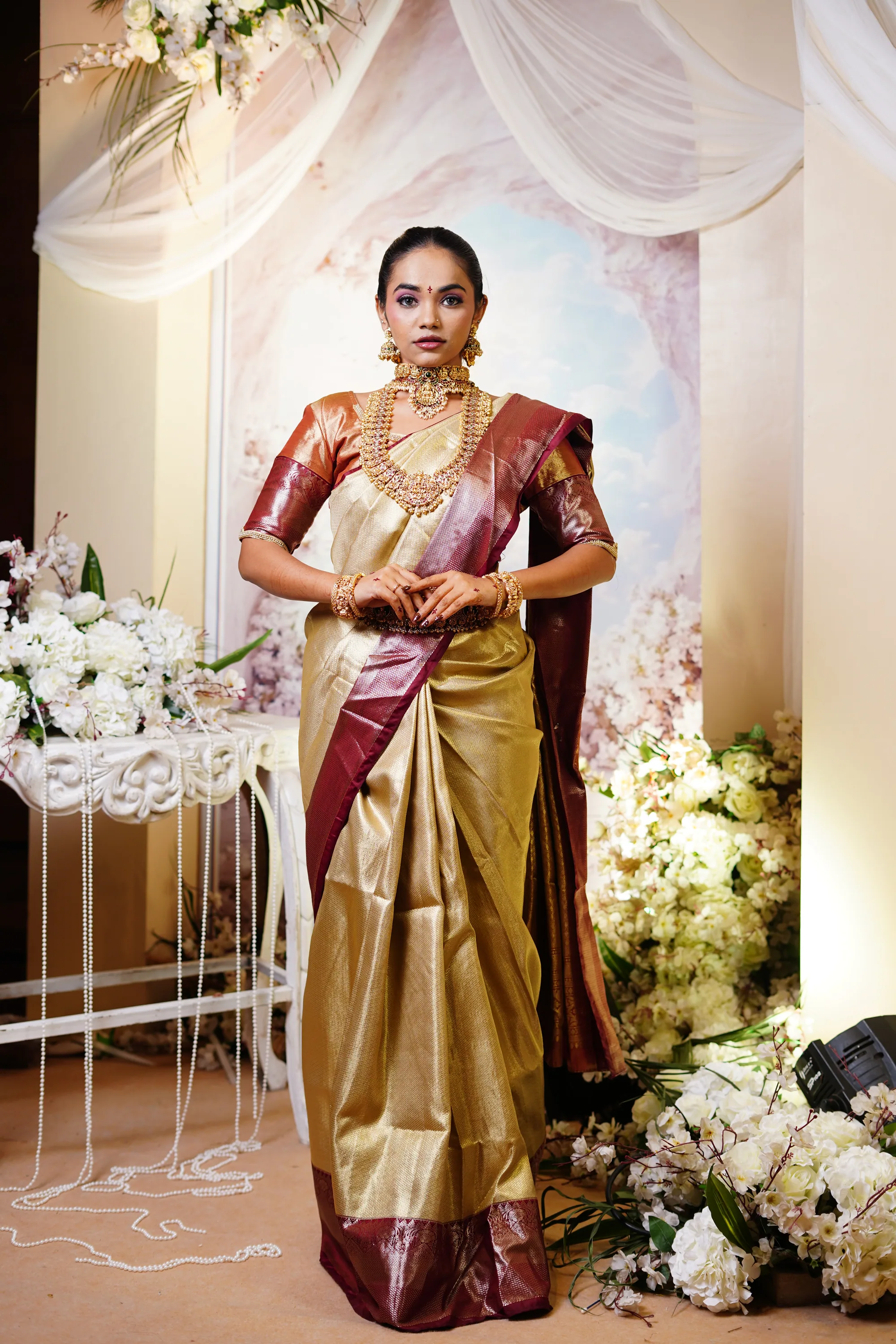 Bride in a gold tissue Kanjivaram with temple jewellery