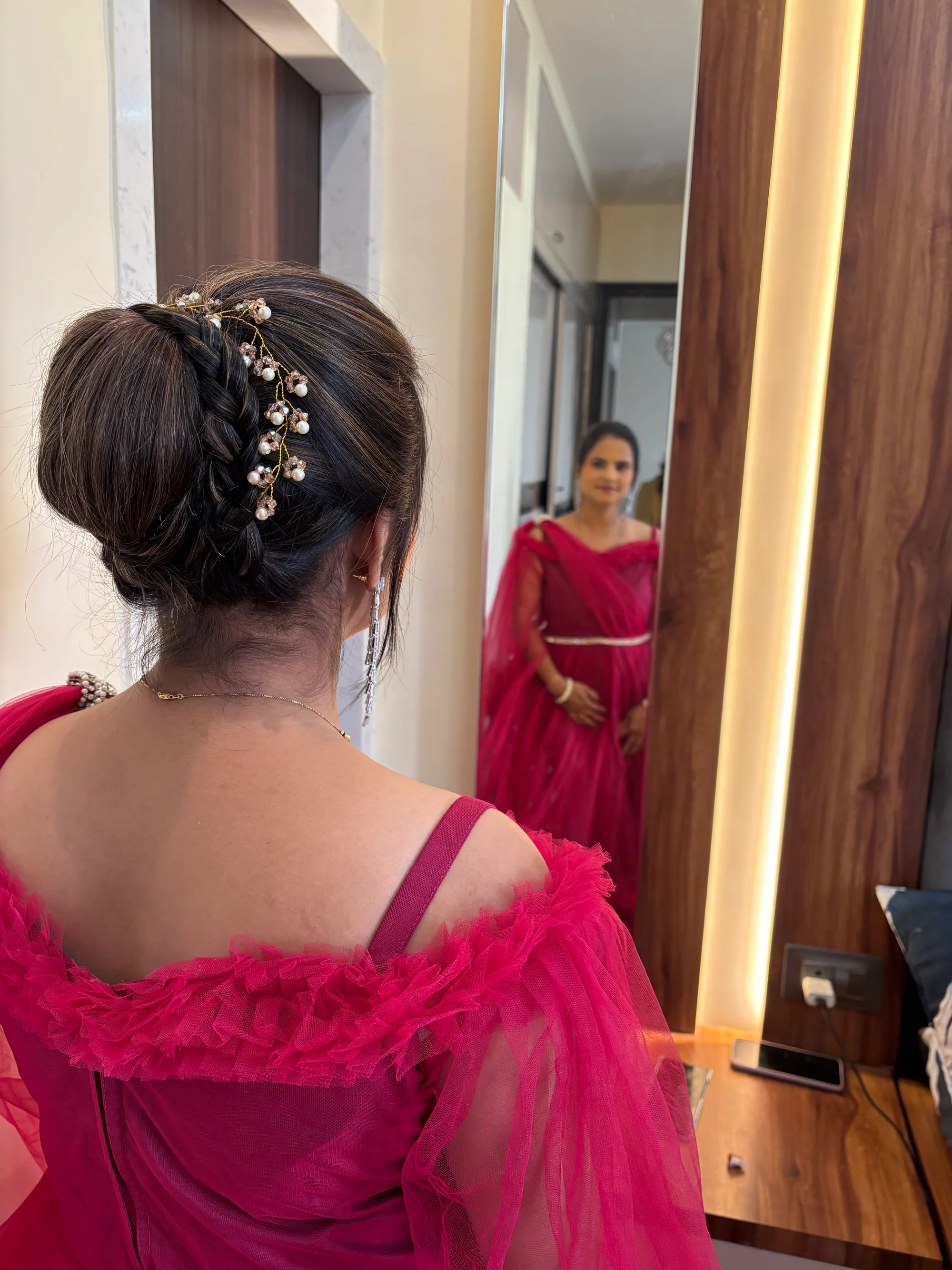 Bridal updo dressed with a pearl and crystal vine