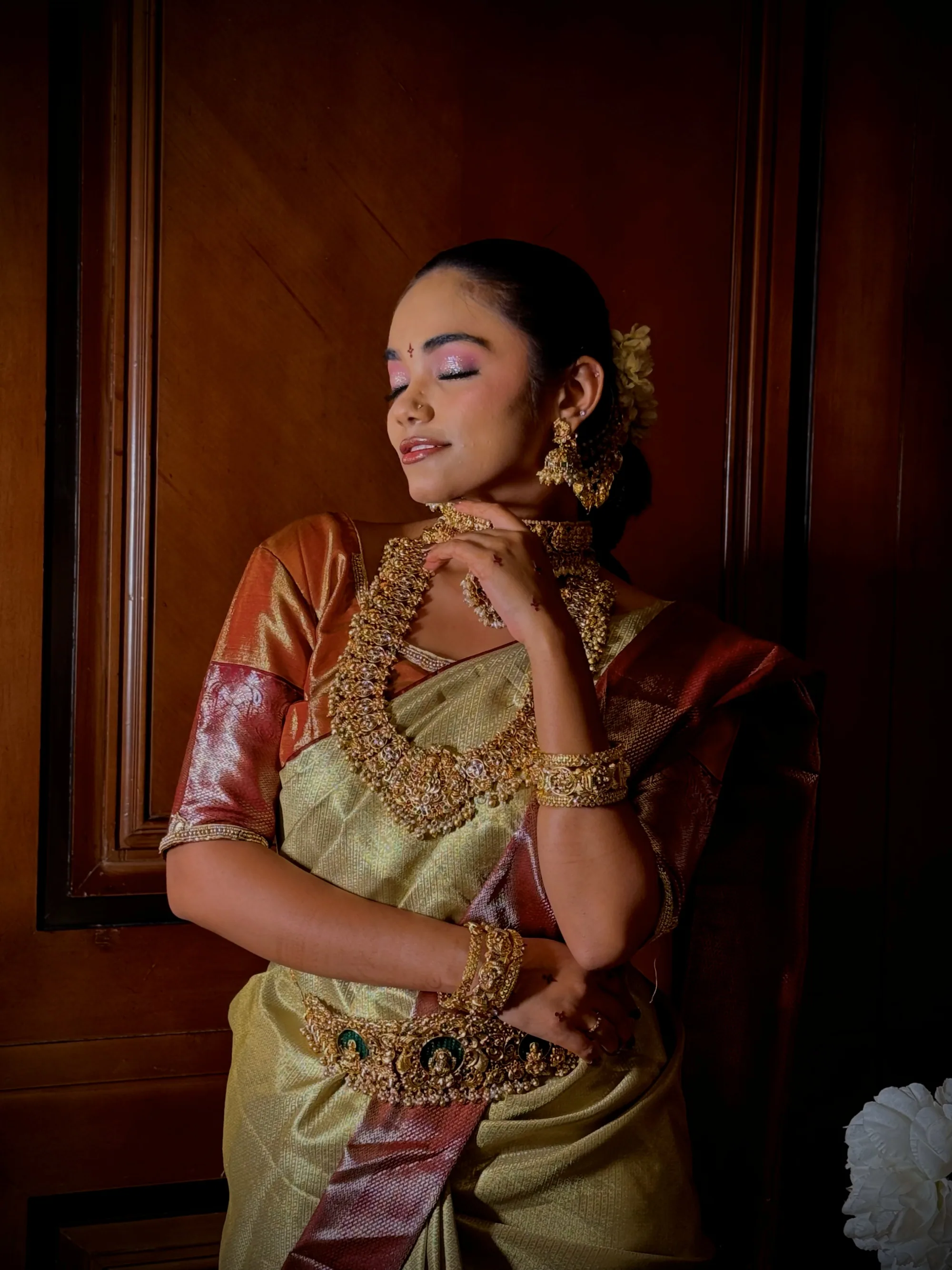 Gold tissue bride with eyes lowered, warm side light