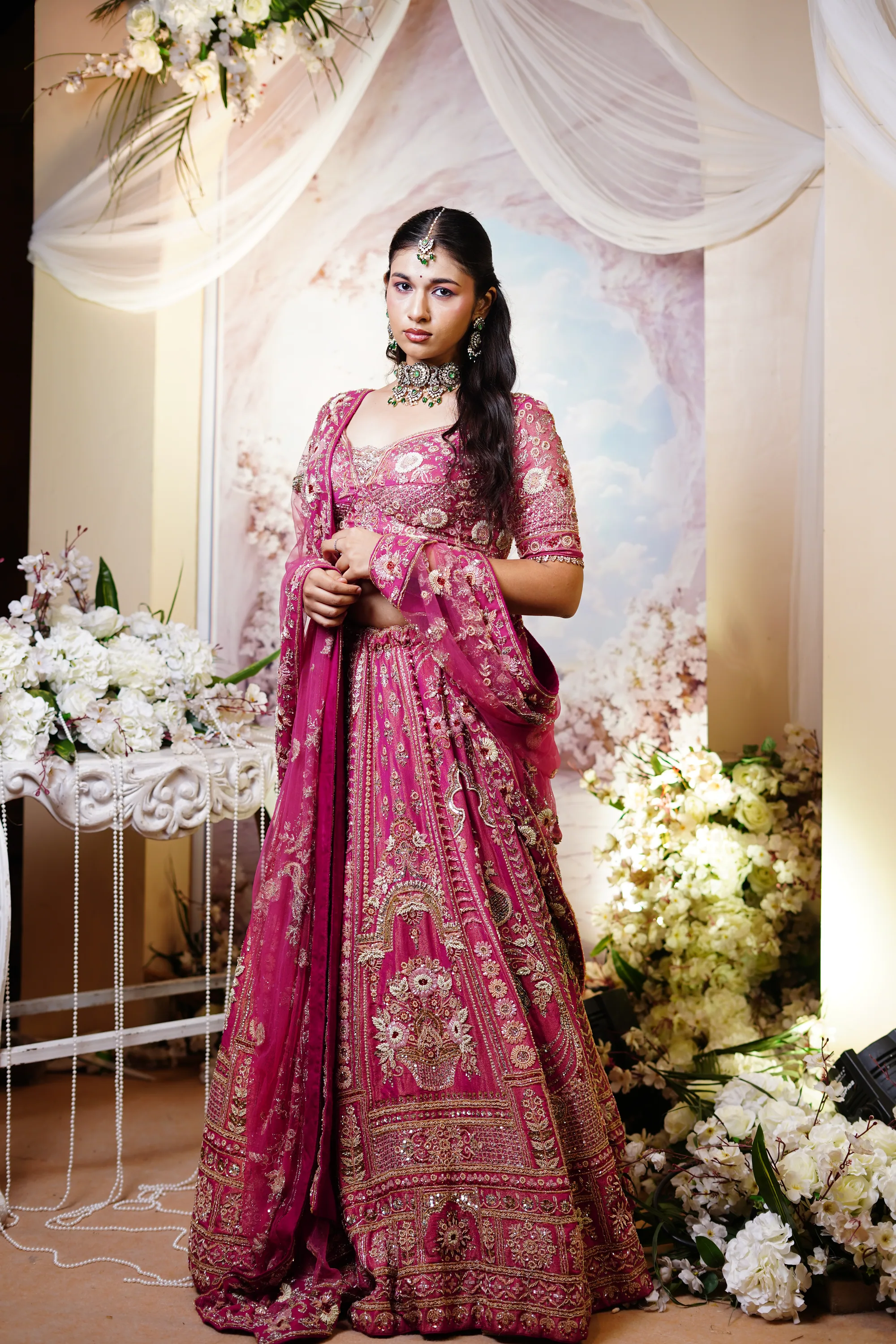 Bride in a magenta embroidered lehenga, full length
