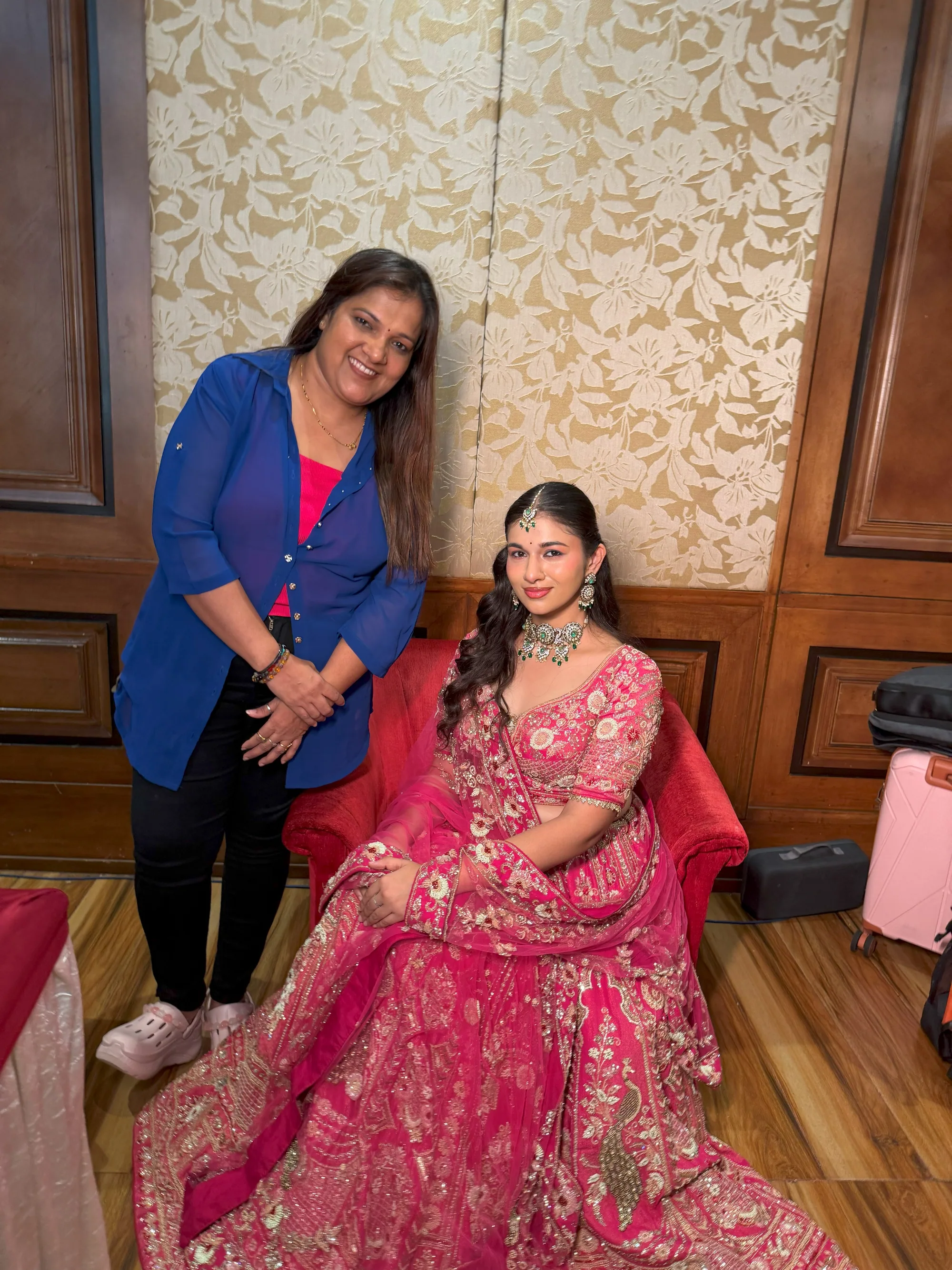 Neha with a bride in a pink lehenga after her makeup
