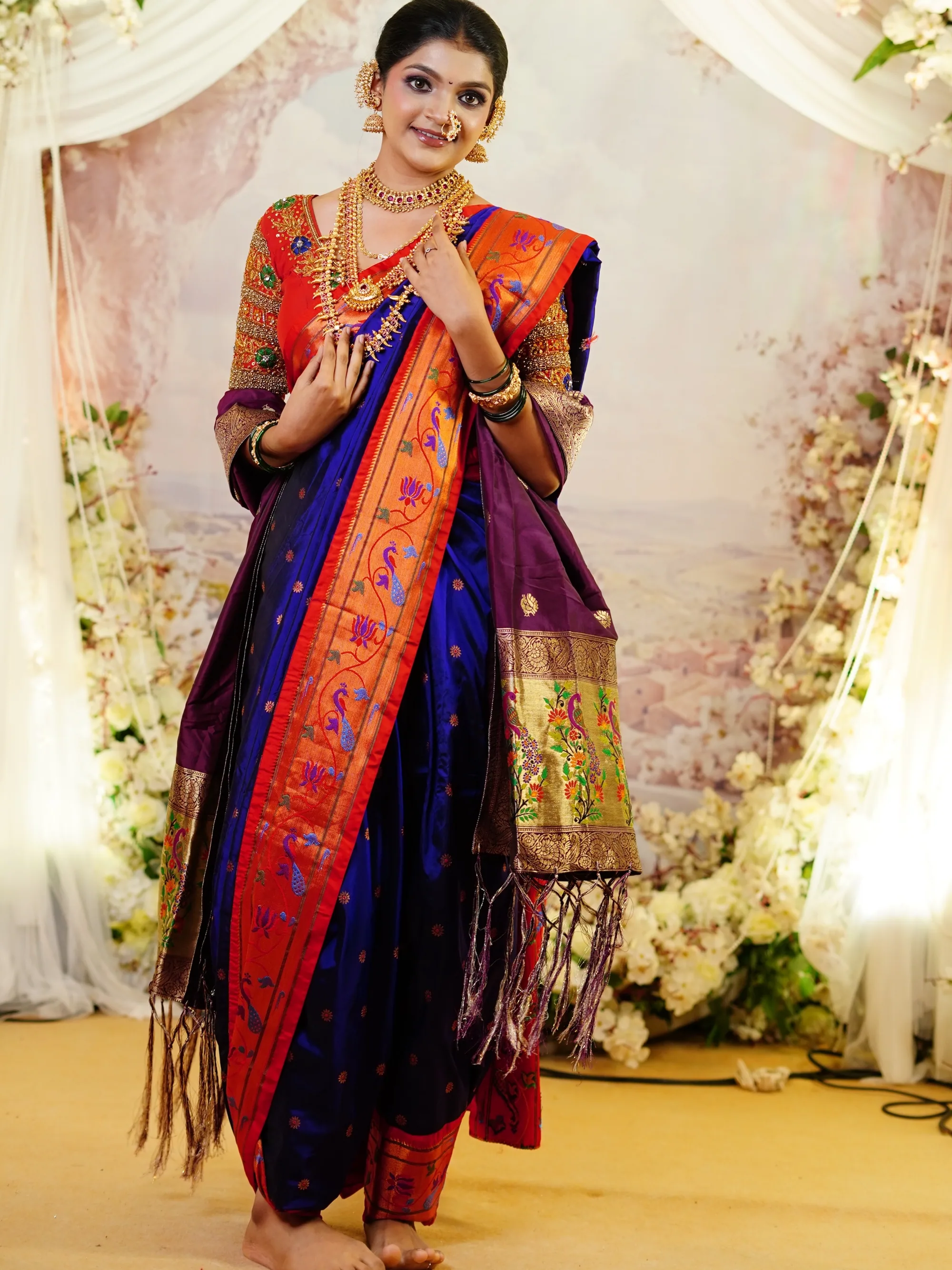 Maharashtrian bride in a blue and orange paithani nauvari