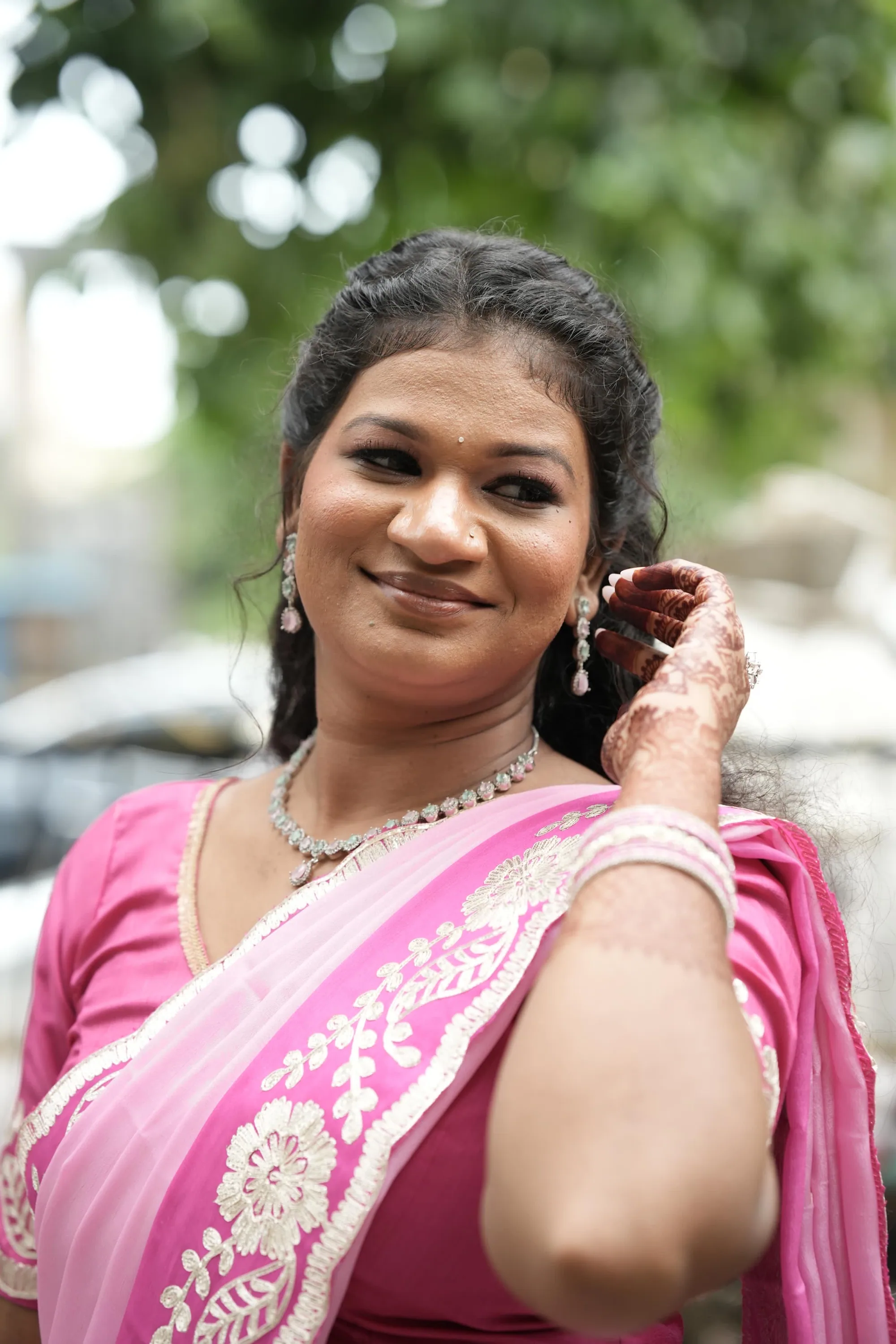 Bride in a pink saree with mehndi on her hand